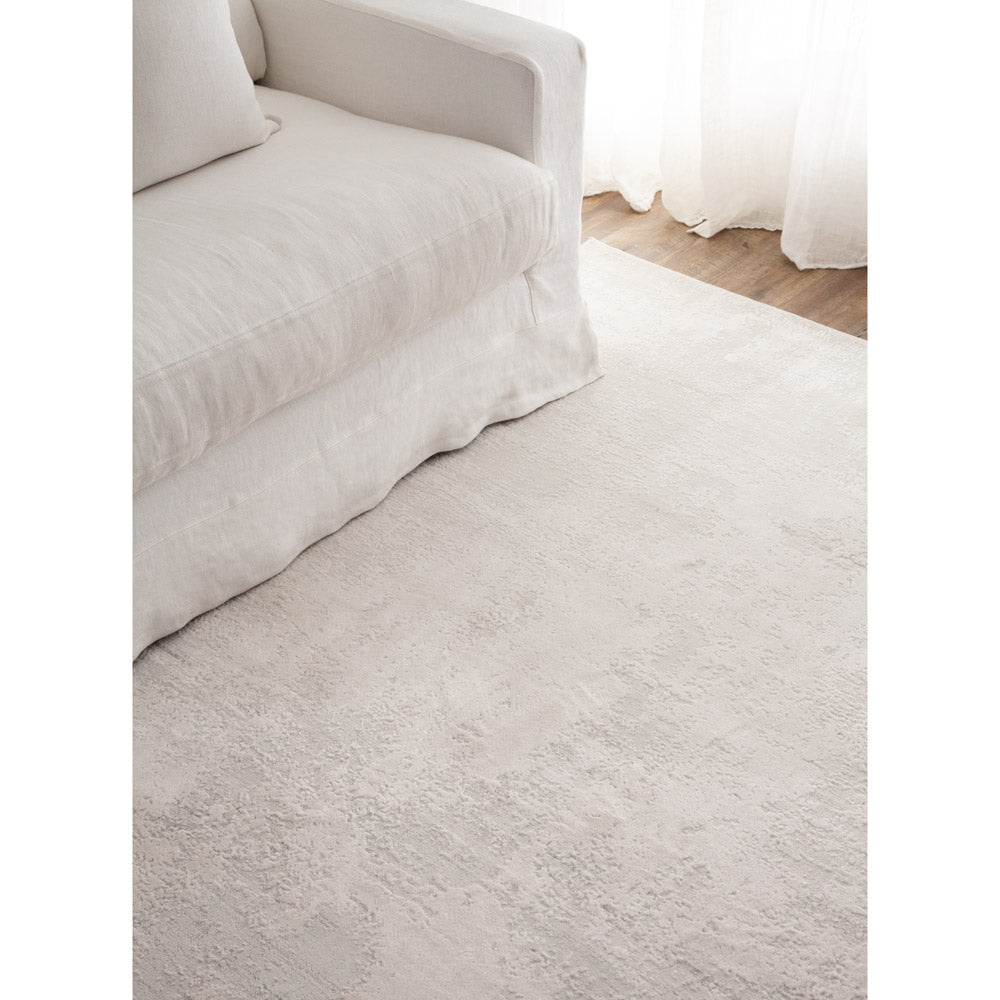 White Alba floor rug with white sofa.