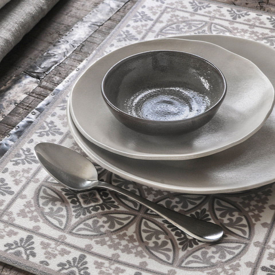 Barcelona grey tile design placemats with plates and spoon.
