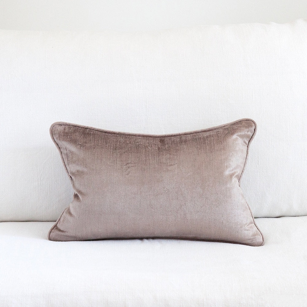 Mauve crushed velvet cushion on white sofa.
