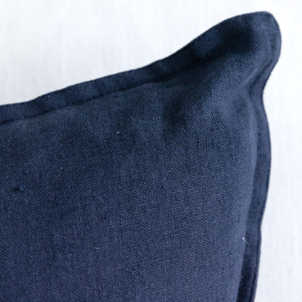 Close up of navy blue linen cushion.