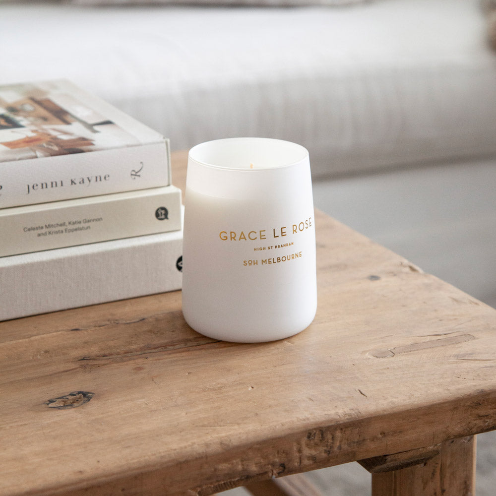 SoH Grace Le Rose Candle on wooden coffee table.