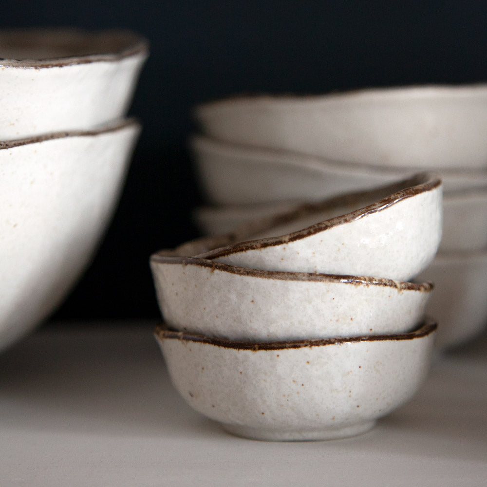 Little Shirokaratsu ceramic dishes in a stack.