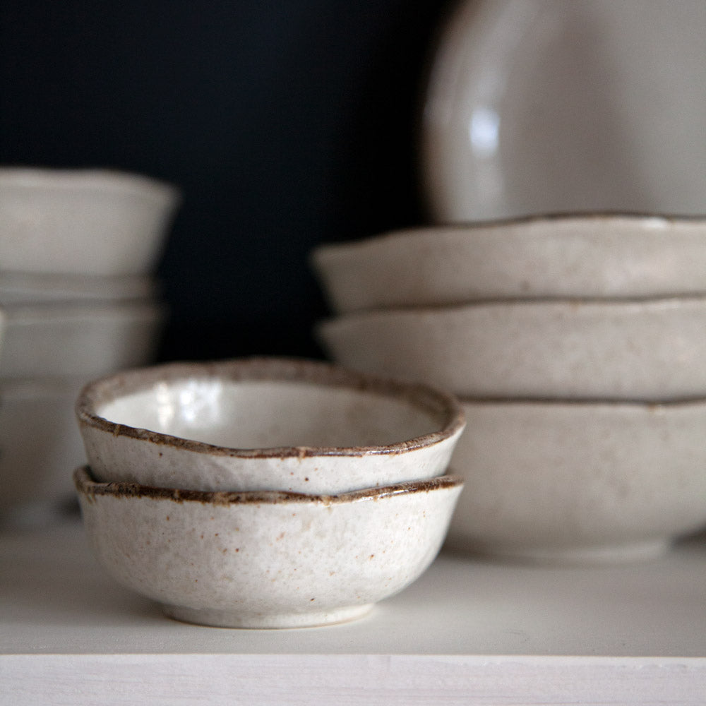 Little Shirokaratsu ceramic dishes in a stack.