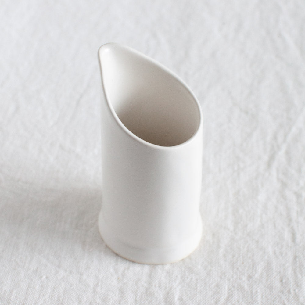Small straight jug with angled top.