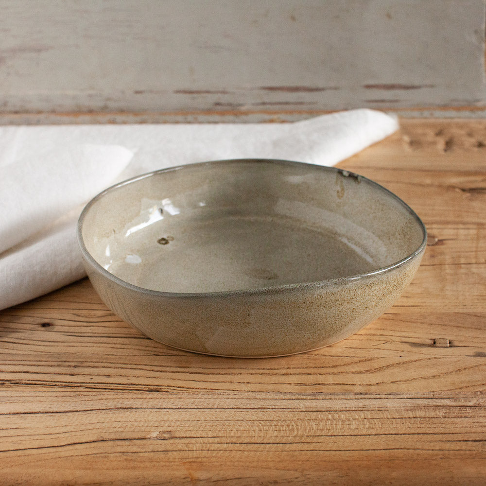 Ceramic serving bowl with flat base.