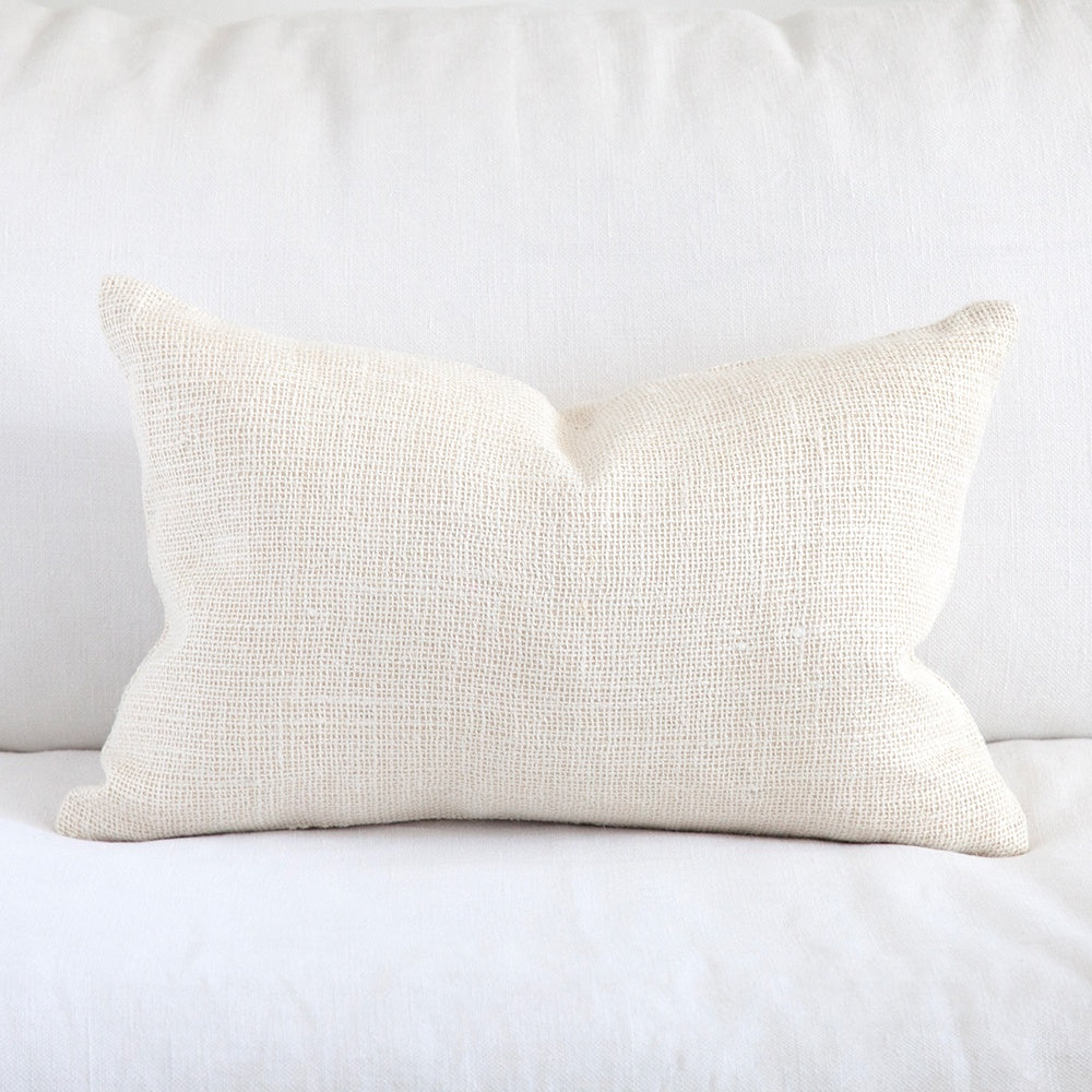 Ivory coloured open weave silk cushion.