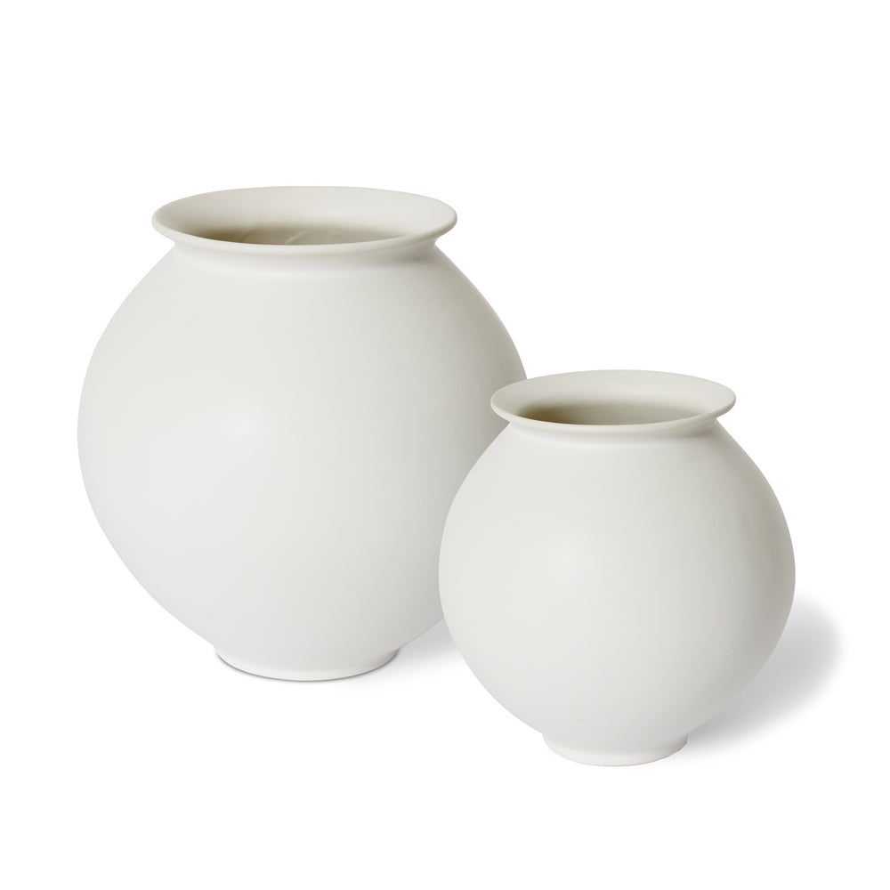 Pair of white round ceramic vases.