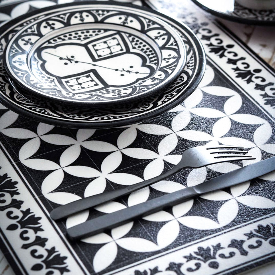 Black and white tile design placemat set for a meal.