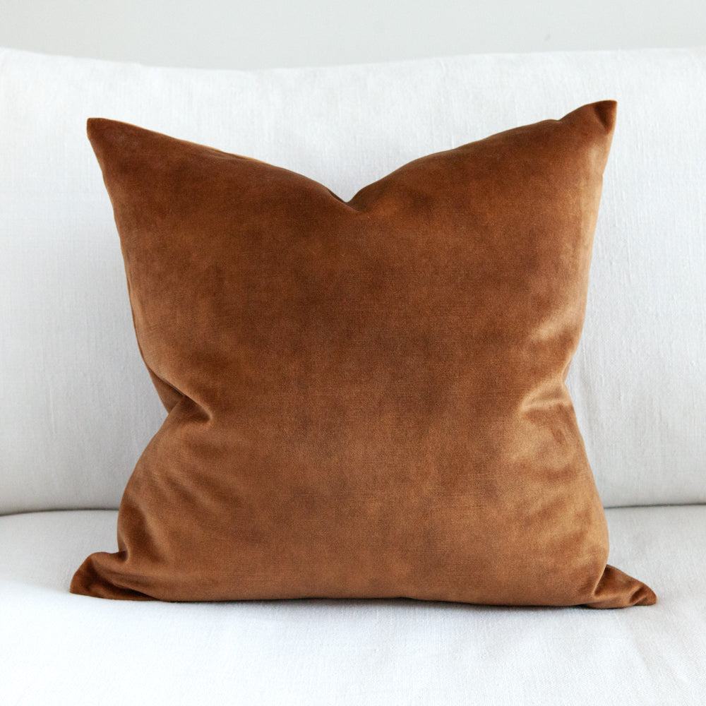 Square ochre brown velvet cushion. 