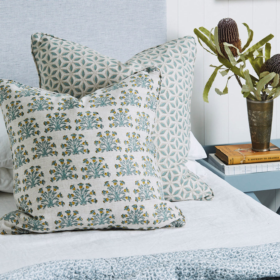 Walter G celadon cushions styled on bed.